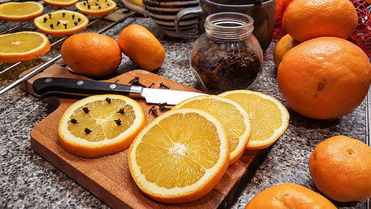 sliced orange fruits on chopping board