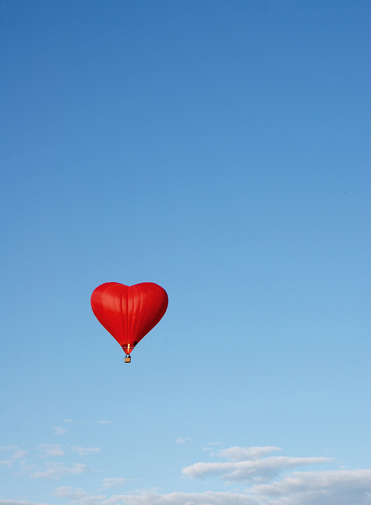 red heart hot air balloon flying on air