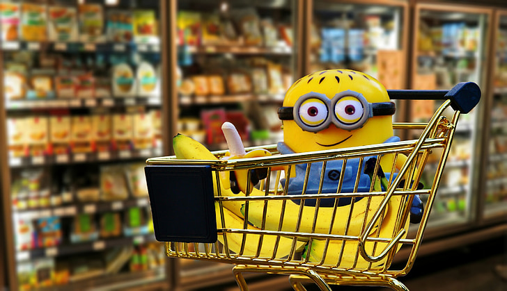 minion plush toy on gold shopping cart