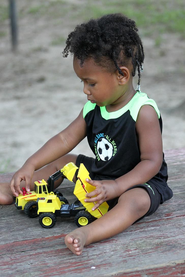 boy playing truck toy
