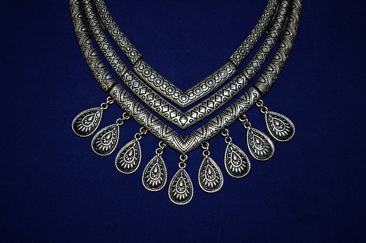 photo of silver-colored 3-layered bib necklace