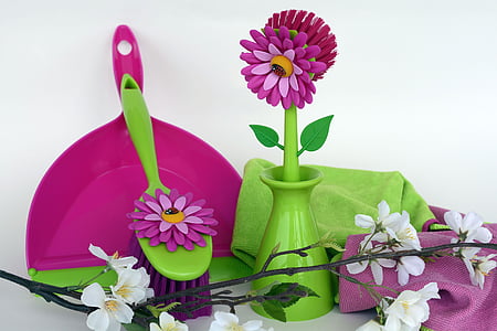 purple plastic dust pan near green and pink flower figurine