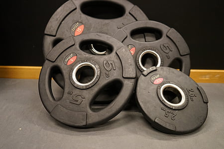 photo of four black weight plates