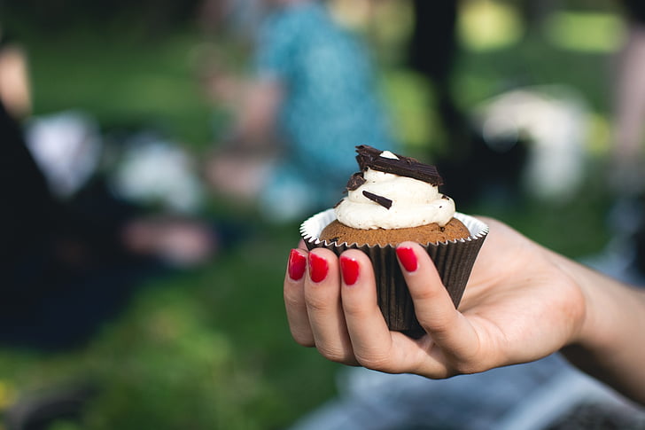 person holding cupcake