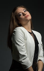 woman wearing grey crop blazer while leaning her head backward