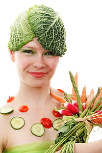 woman holding vegetables while showing smile
