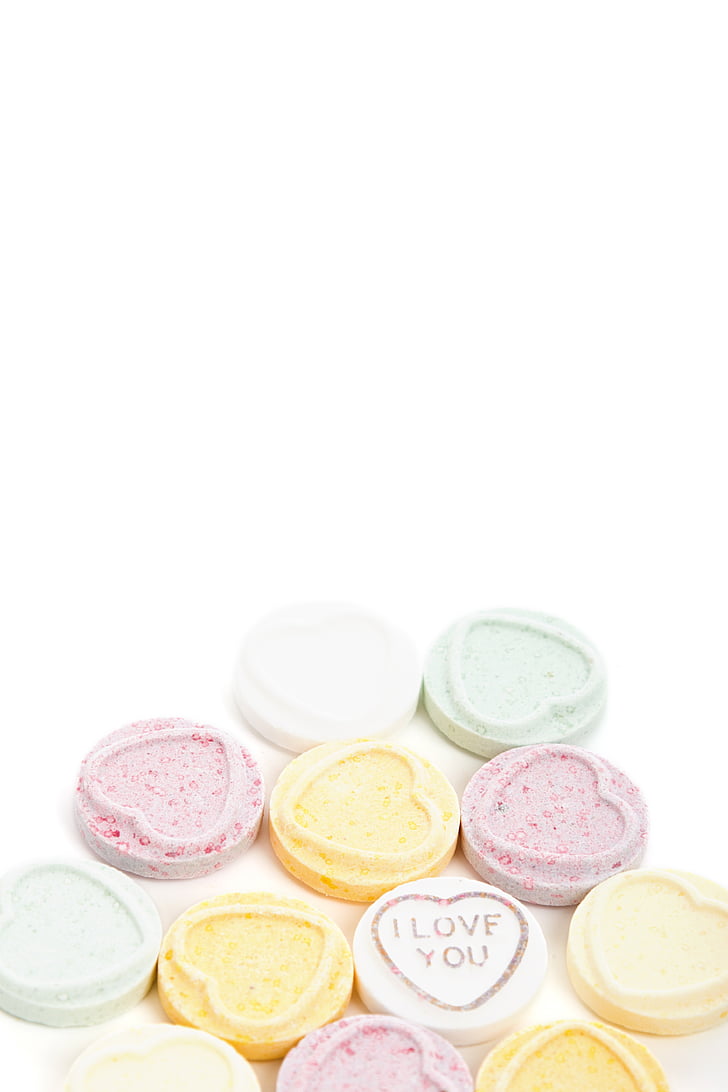 heart-shaped assorted-color candies on white pad