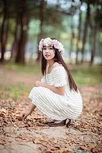 shallow focus photography of woman in white off-shoulder dress