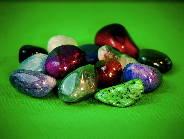 assorted color stones with green background