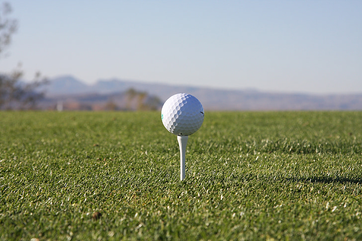 selective focus photography of golf ball on golf tee