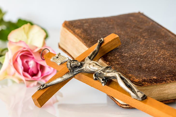 crucifix and bible on table