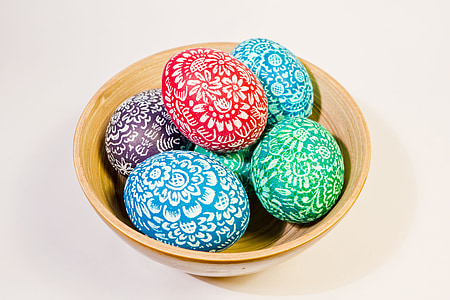 six assorted-color egg decors on brown ceramic bowl