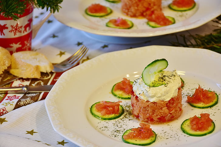 sliced cucumbers with cream on white ceramic plate