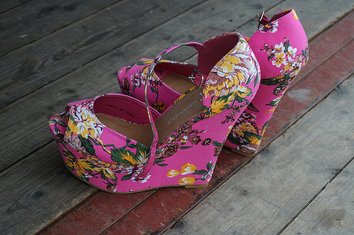 Royalty-Free photo: Pink-yellow-and-green floral peep-toe wedge sandals