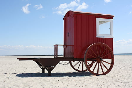 red carriage cabin near seashore during daytime