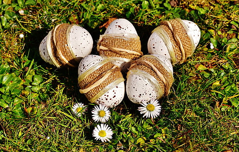 five white Easter eggs on the ground