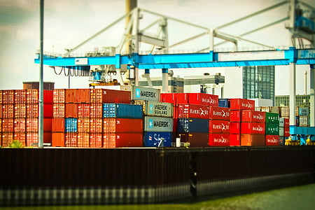 red and blue ship containers at daytime