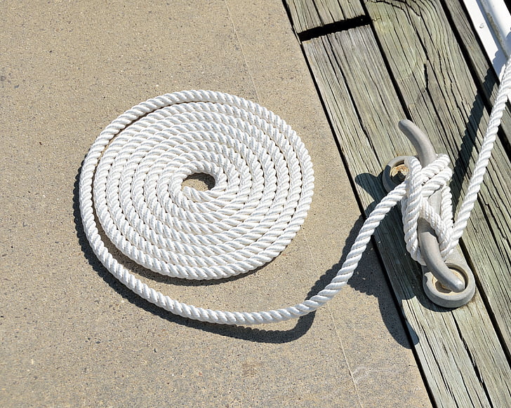 Royalty-Free photo: Close up photo of white rope tie on buckle
