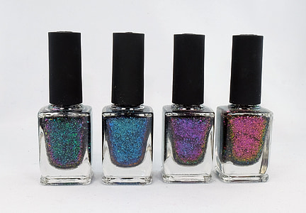 four assorted-color glitter nail polishes