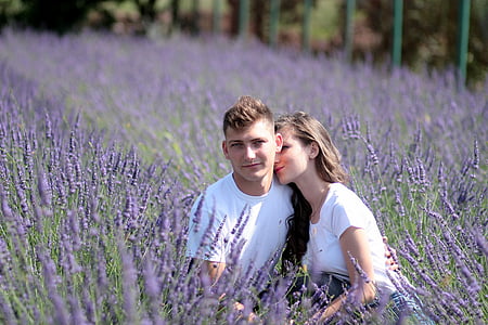 shallow focus photography of man and woman in white shirts at lavender field during daytime