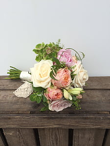 white, pink, and beige rose flower bouquet on brown surface