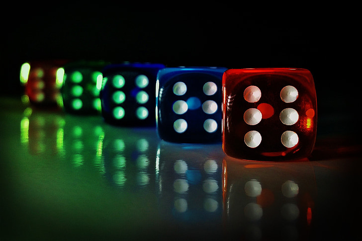 selective focus photography of five dices reflecting on surface