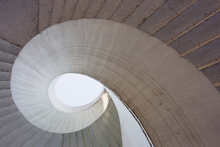 low-angle photography of spiral stair