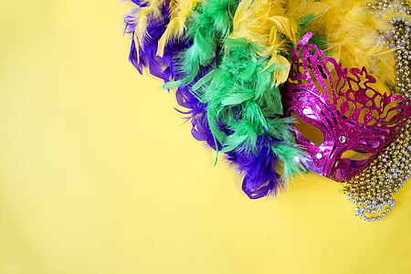 multicolored party mask on yellow surface