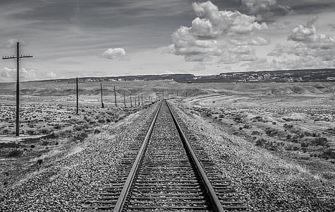 greyscale photo train rails