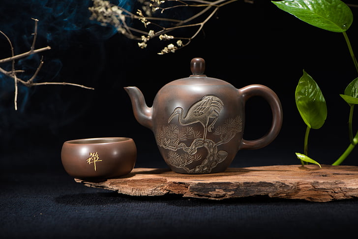 brown ceramic teapot near brown bowl