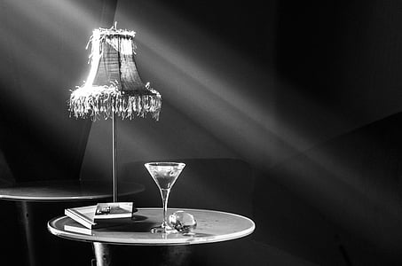 grayscale photography of cocktail glass on table