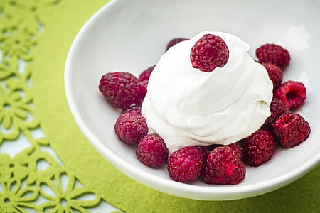 bunch of strawberries with cream on bowl