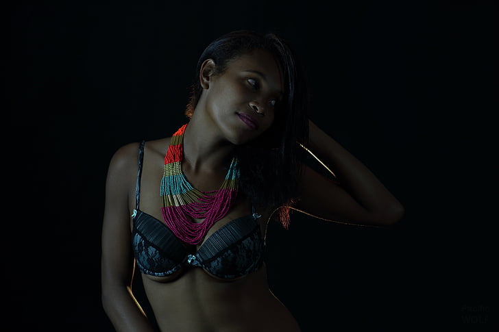 woman wearing bra in dark area