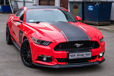 red and black Ford Mustang coupe on concrete road