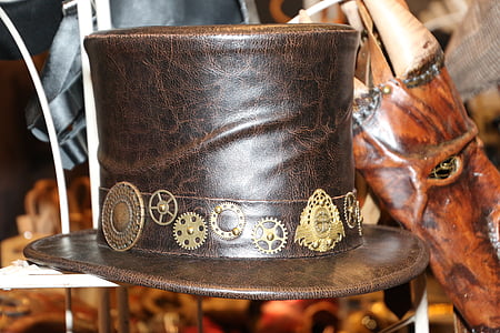 selective photography of brown and black leather hat