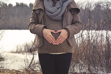 woman wearing brown zip-up jacket and grey knit infinity scarf
