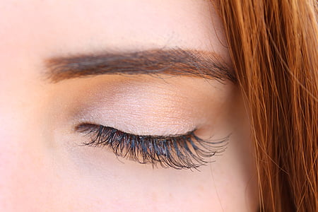 woman's brown colored brow and mascara