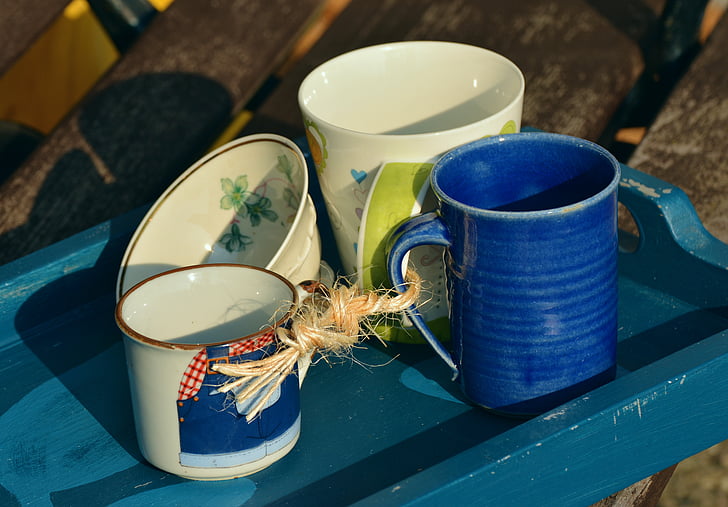 assorted-color ceramic mugs and bowl