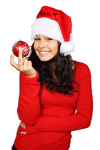 woman in red sweater holding red Christmas bauble