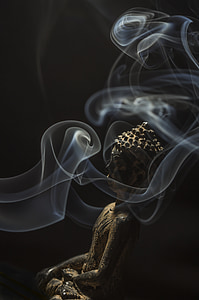 Gautama Buddha figurine surrounded with smoke
