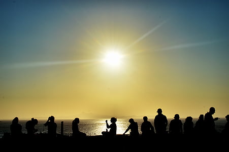 silhouette photo of people gathering during golden hour