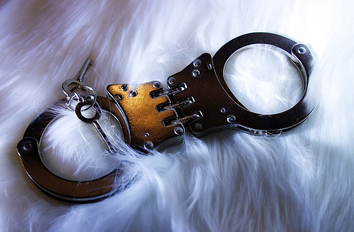 gold and silver handcuffs with keys