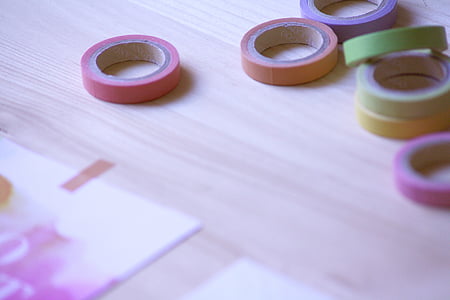 assorted adhesive tapes on brown surface