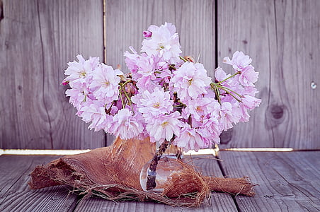 pink petaled flowers centerpiece on brown wooden surface