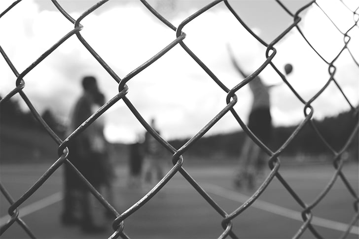 grayscale photography of cyclone fence
