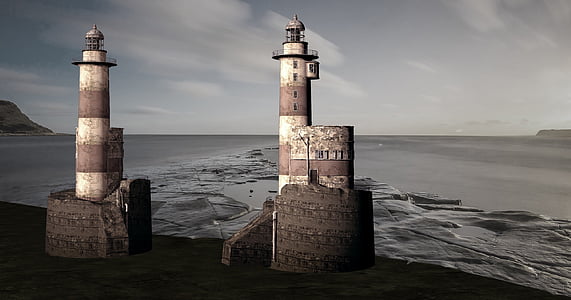 photo of two lighthouses near body of water