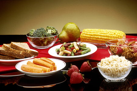 assorted foods with glass and ceramic plates