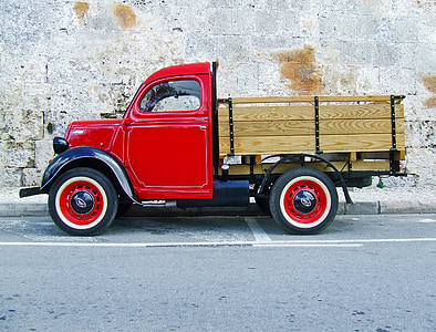 red stake truck on road