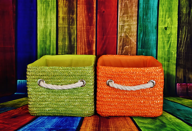 two green and orange fabric baskets on multicolored wooden pallets
