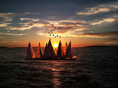 sailboats on body of water during golden hour